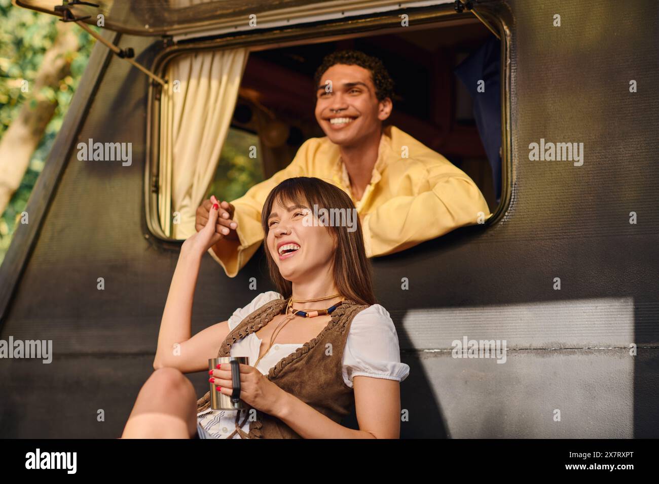 A man and a woman are peacefully seated together on a van, gazing out the window as they travel. Stock Photo