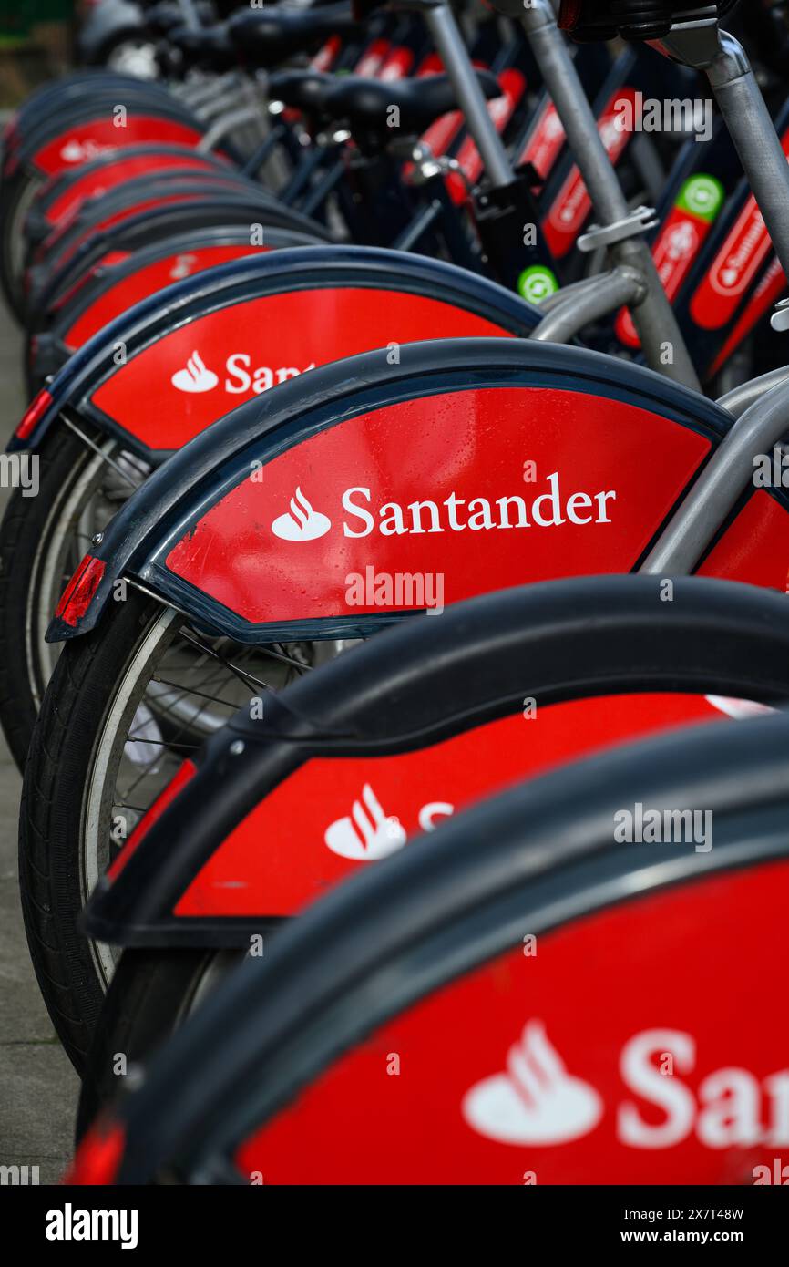 London, UK - March 23, 2024; Closeup of red Santander Cycles in London with company name and logo available for hire Stock Photo