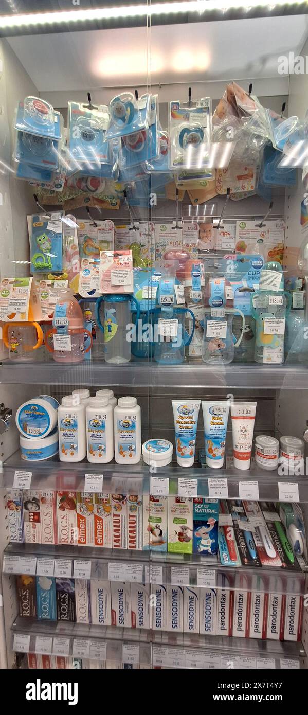 Bobruisk, Belarus - May 1, 2024: A well-organized pharmacy display case showcasing baby pacifiers, feeding bottles, baby powder, baby cream, and tooth Stock Photo