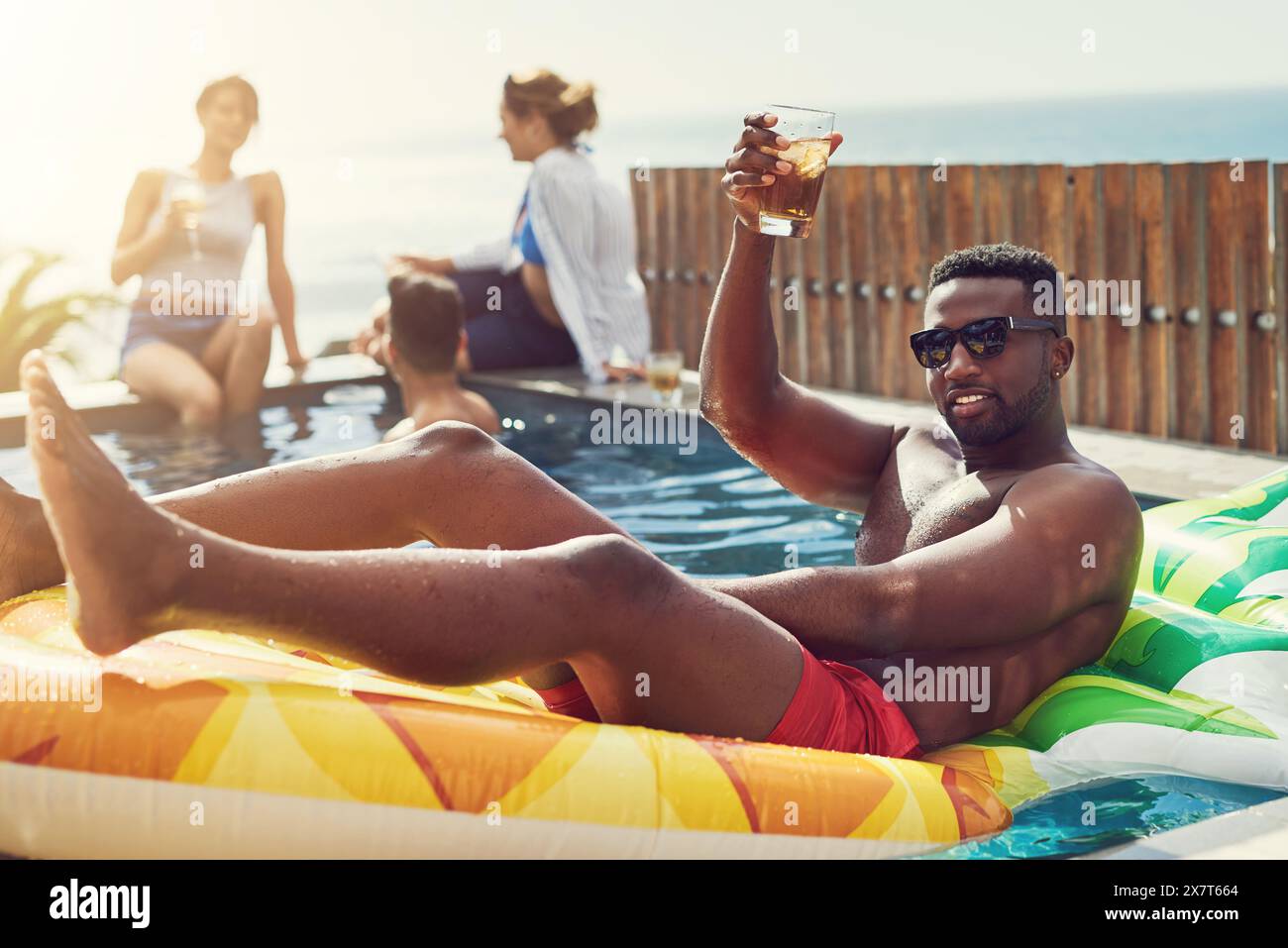 Man, toast drink and float in swimming pool with sunglasses, cheers and ...
