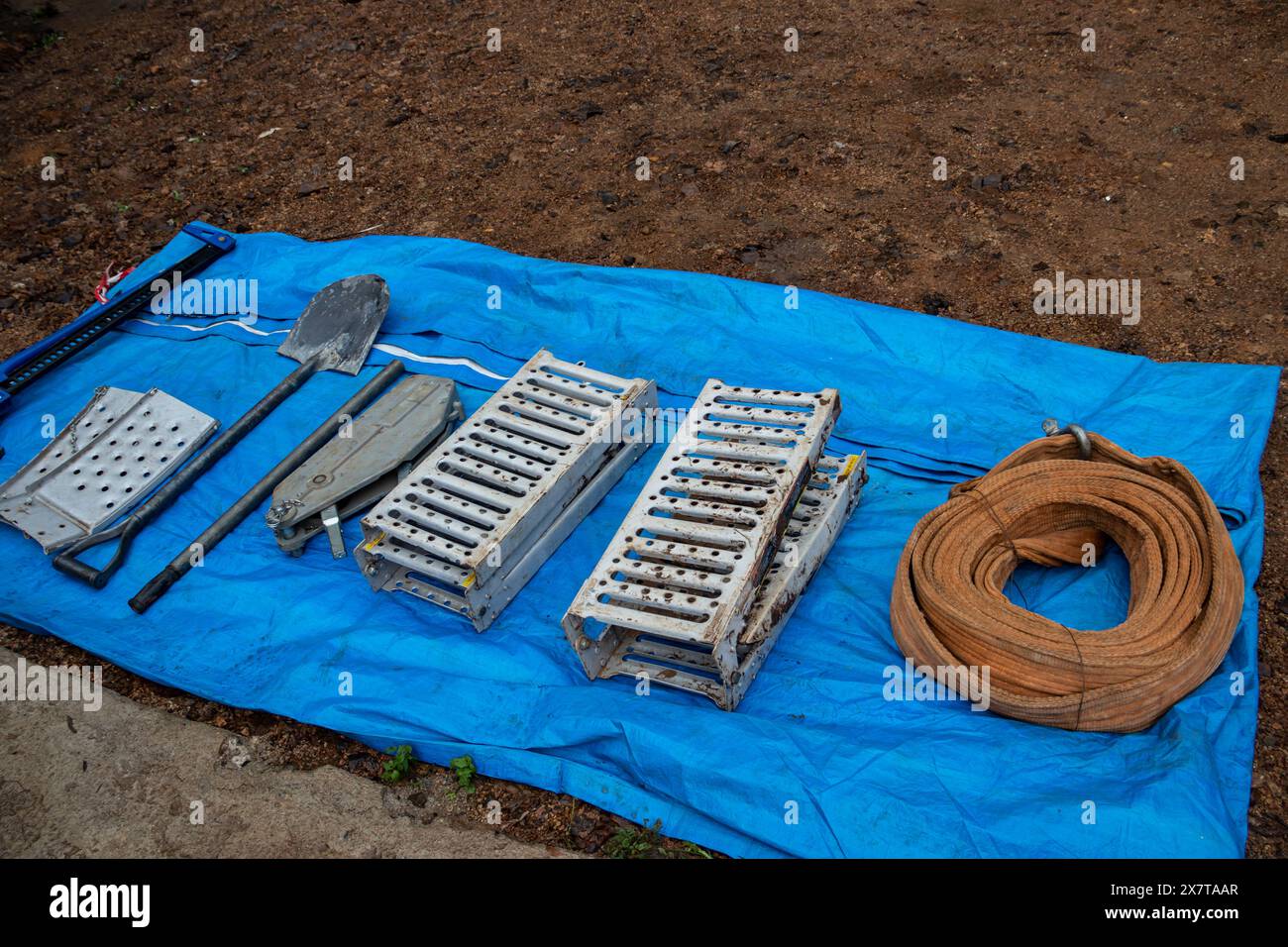 Recovery equipment for unstacking 4x4 vehicle out of muddy road ready to use, sand plates, mechanical winch, pooling ropes, high lift jack, shovel. Stock Photo