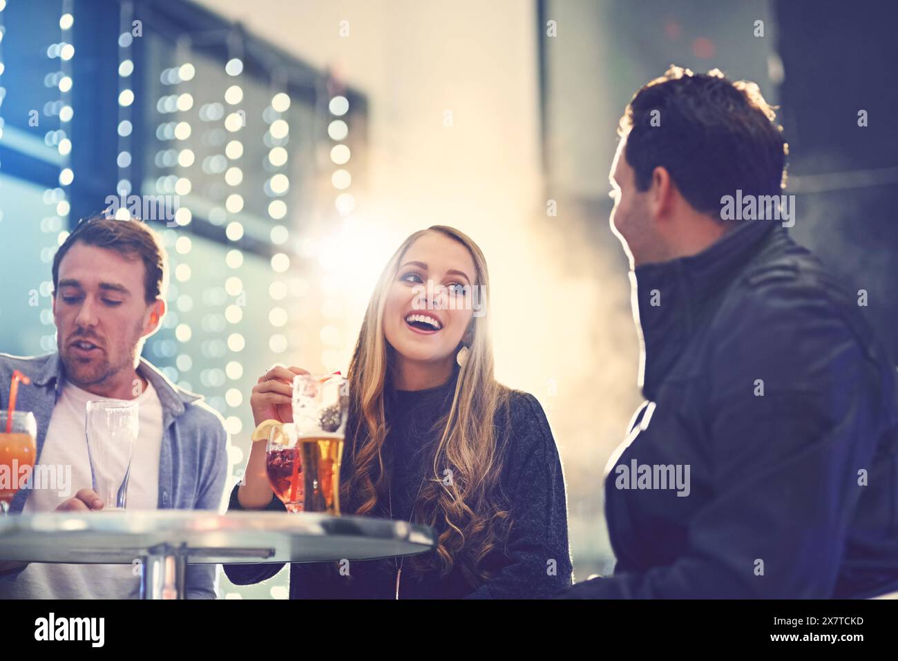 Friends, group and nightclub with alcohol drinks or relax conversation ...