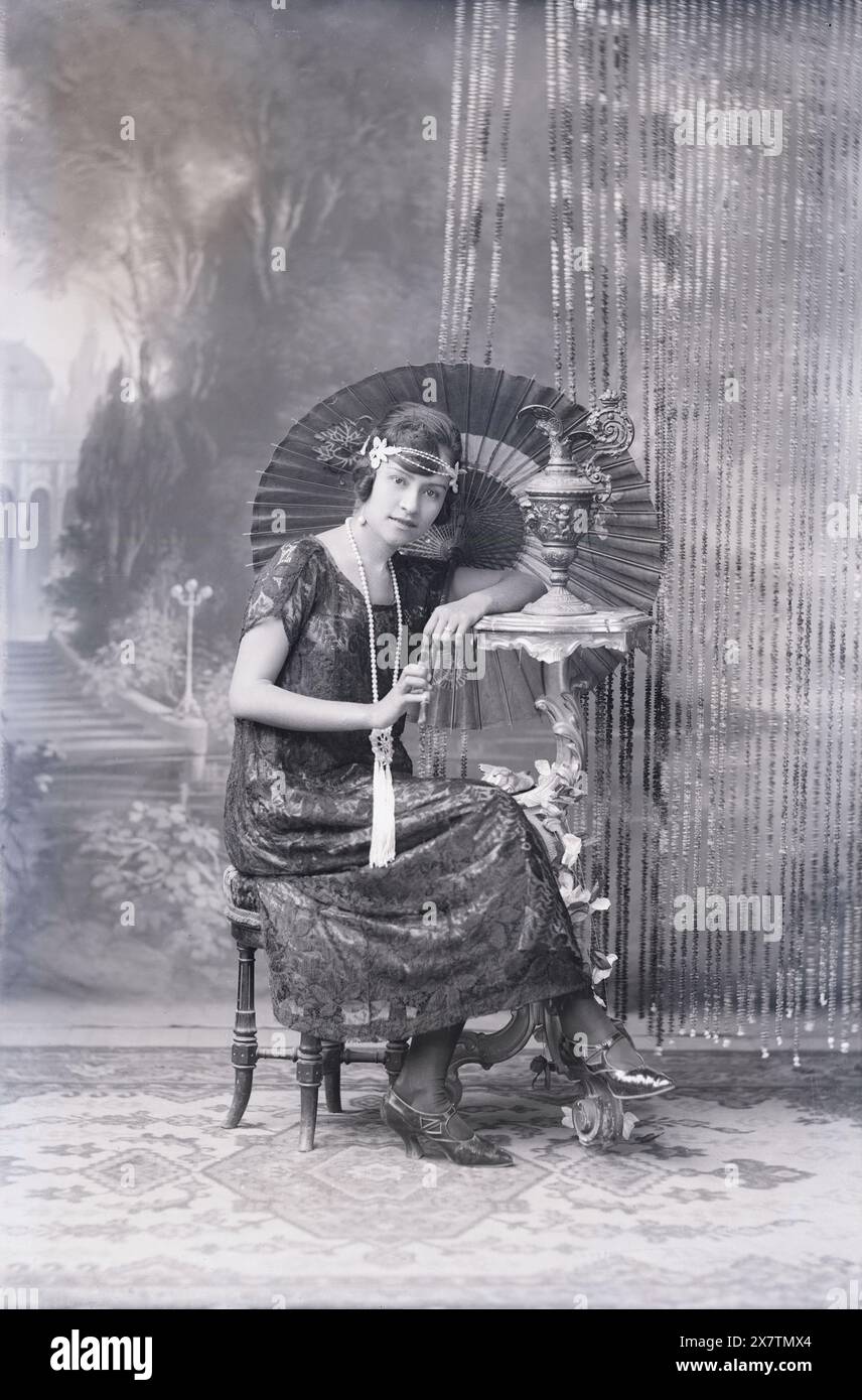 Antique 1920s photograph, young woman dressed in roaring twenties fashion. Exact location unknown, USA. SOURCE: ORIGINAL GLASS NEGATIVE Stock Photo