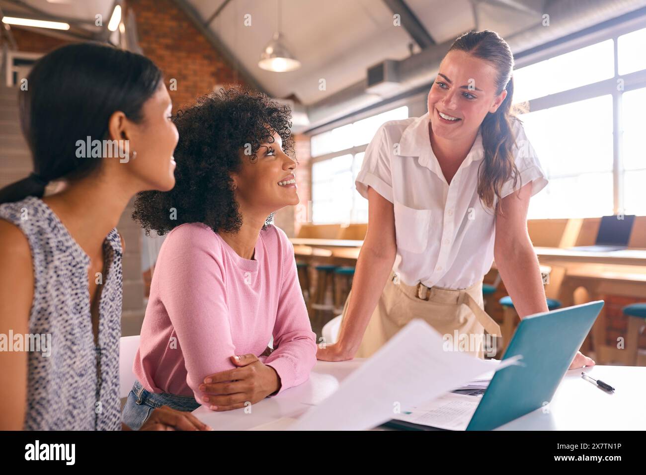 Three businesswomen meeting around table hi-res stock photography and ...
