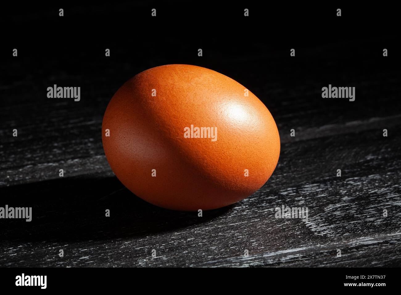 brown egg on black wood background Stock Photo