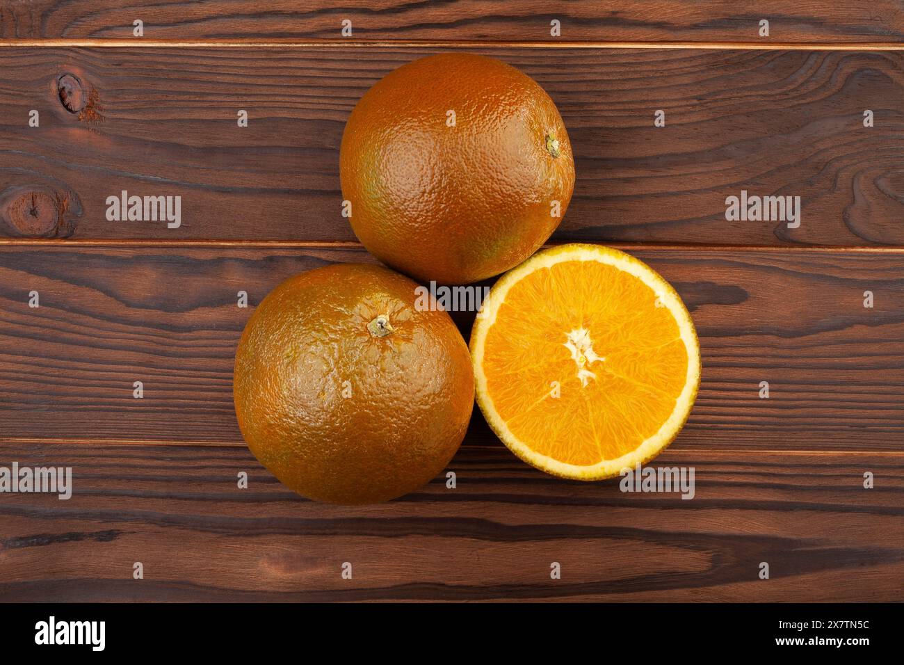 sliced chocolate oranges on wood background Stock Photo