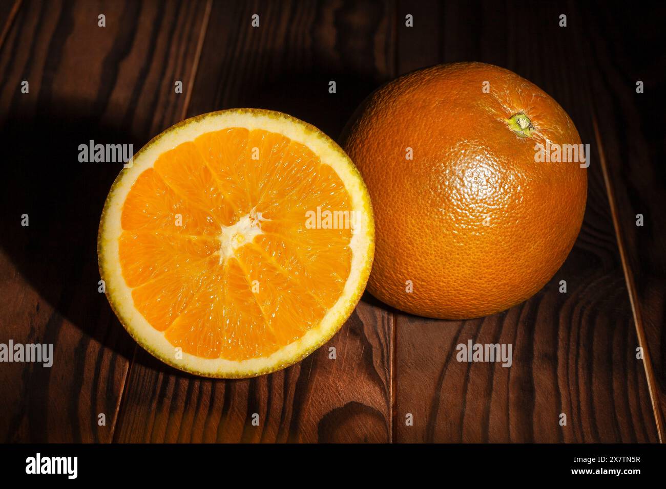 sliced chocolate oranges on wood background Stock Photo