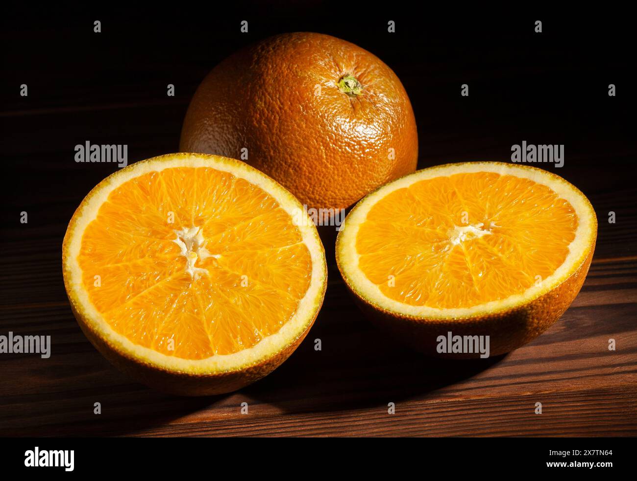 sliced chocolate oranges on wood background Stock Photo