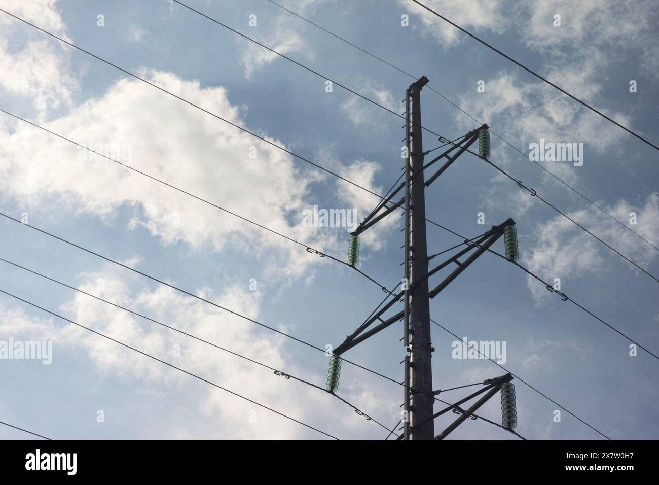 Power lines and a pylon on a cloudy sky background. Close up Stock ...