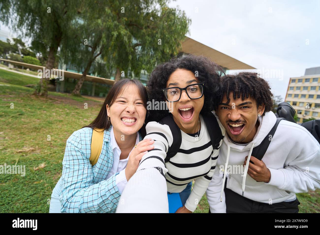 three young multiethnic students taking selfie Stock Photo