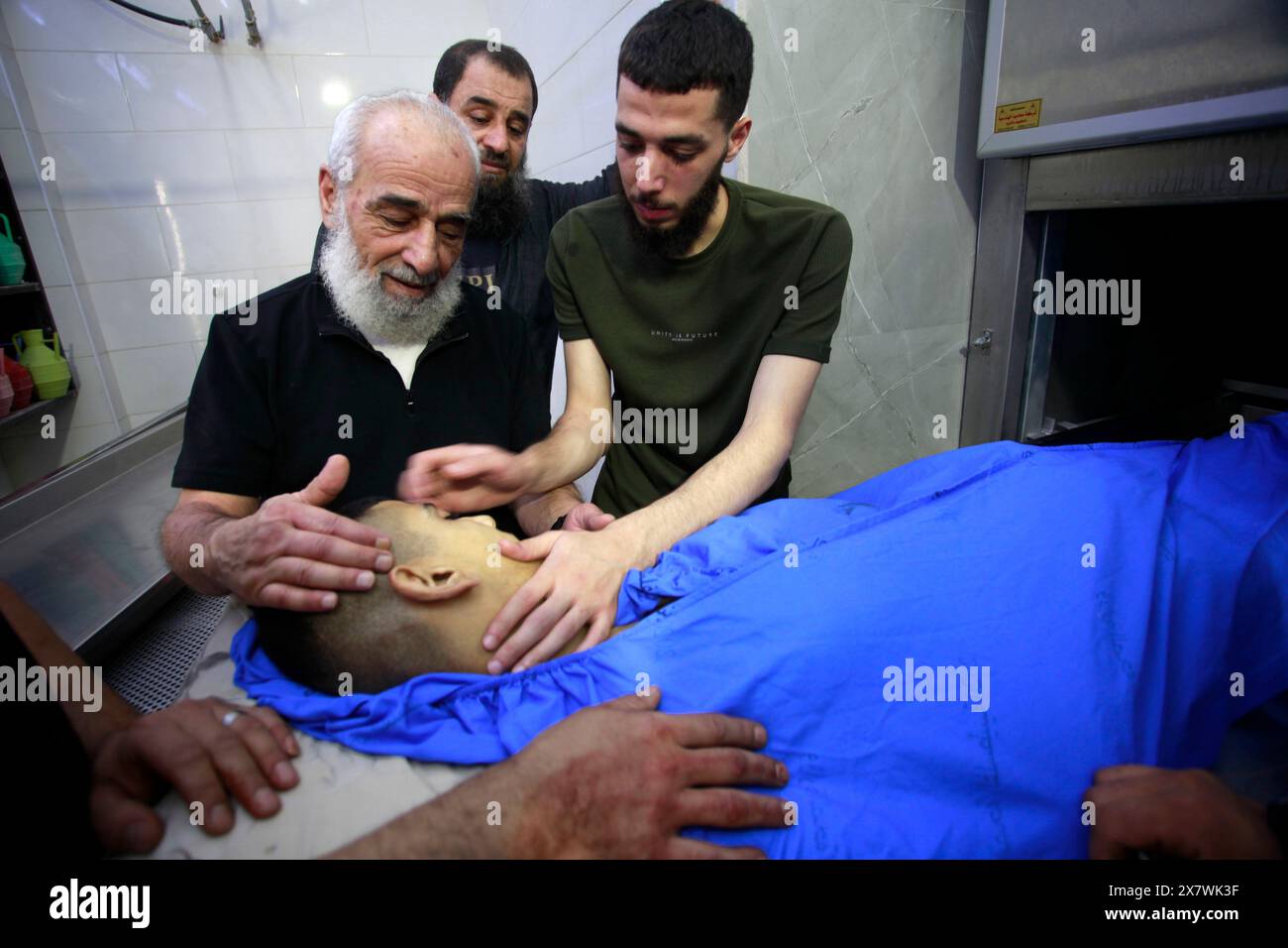 May 21, 2024, Jenin, West Bank, Palestine: (EDITORS NOTE: Image depicts death).Relatives seen next to the body of one of seven Palestinians who were shot dead by Israeli forces during a military operation in the Jenin refugee camp. In the northern West Bank camp, during a military operation searching for Palestinian militants from the Jenin Brigade. The Palestinian Ministry of Health said that 7 Palestinian civilians were killed, including two doctors, a teacher, and a student who was on his way to school during the military operation. (Credit Image: © Nasser Ishtayeh/SOPA Images via ZUMA Pres Stock Photo