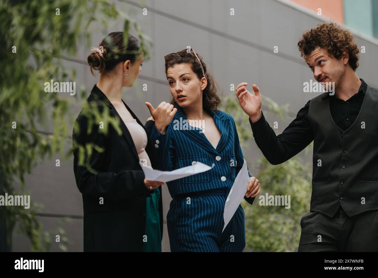 Business professionals having a discussion outside office building Stock Photo
