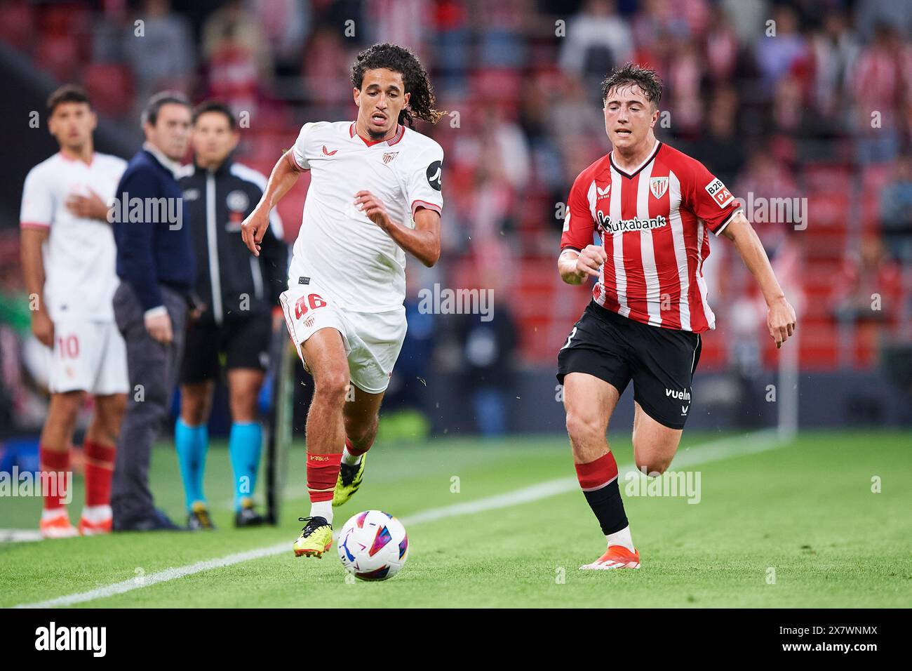 Hannibal Mejbri of Sevilla FC compete for the ball with Mikel Jauregizar of Athletic Club during the LaLiga EA Sports match between Athletic Club and Stock Photo