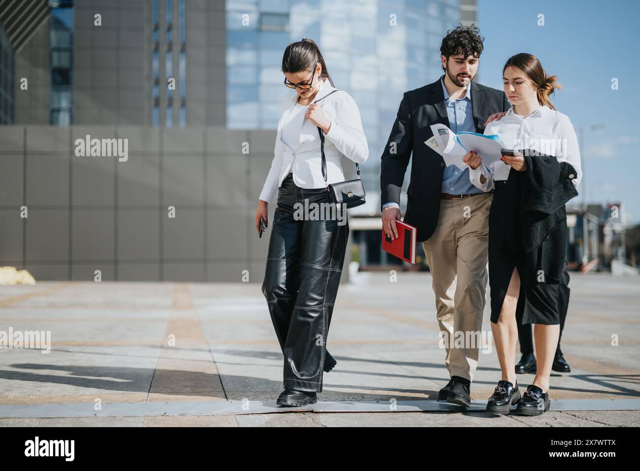 Multicultural business team discussing strategy outdoors Stock Photo