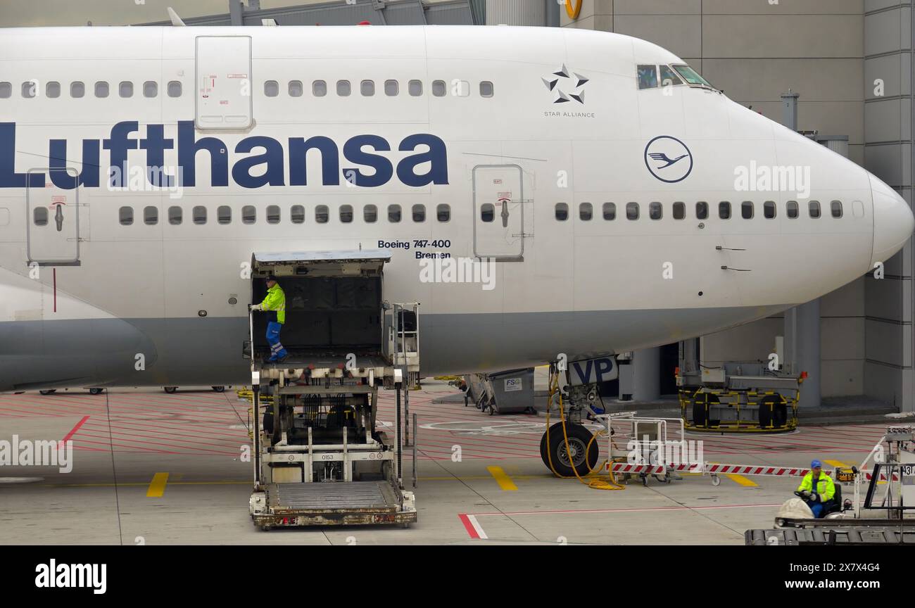 Ground staff loading air cargo in a Boeing 747 before departure, Frankfurt airport DE Stock Photo