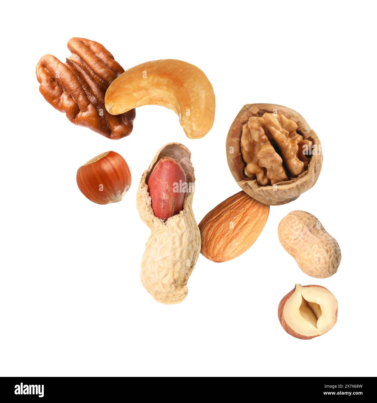 Many different nuts in air on white background Stock Photo