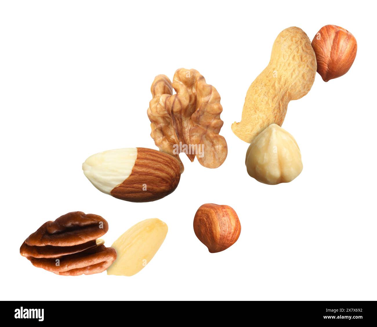 Many different nuts in air on white background Stock Photo