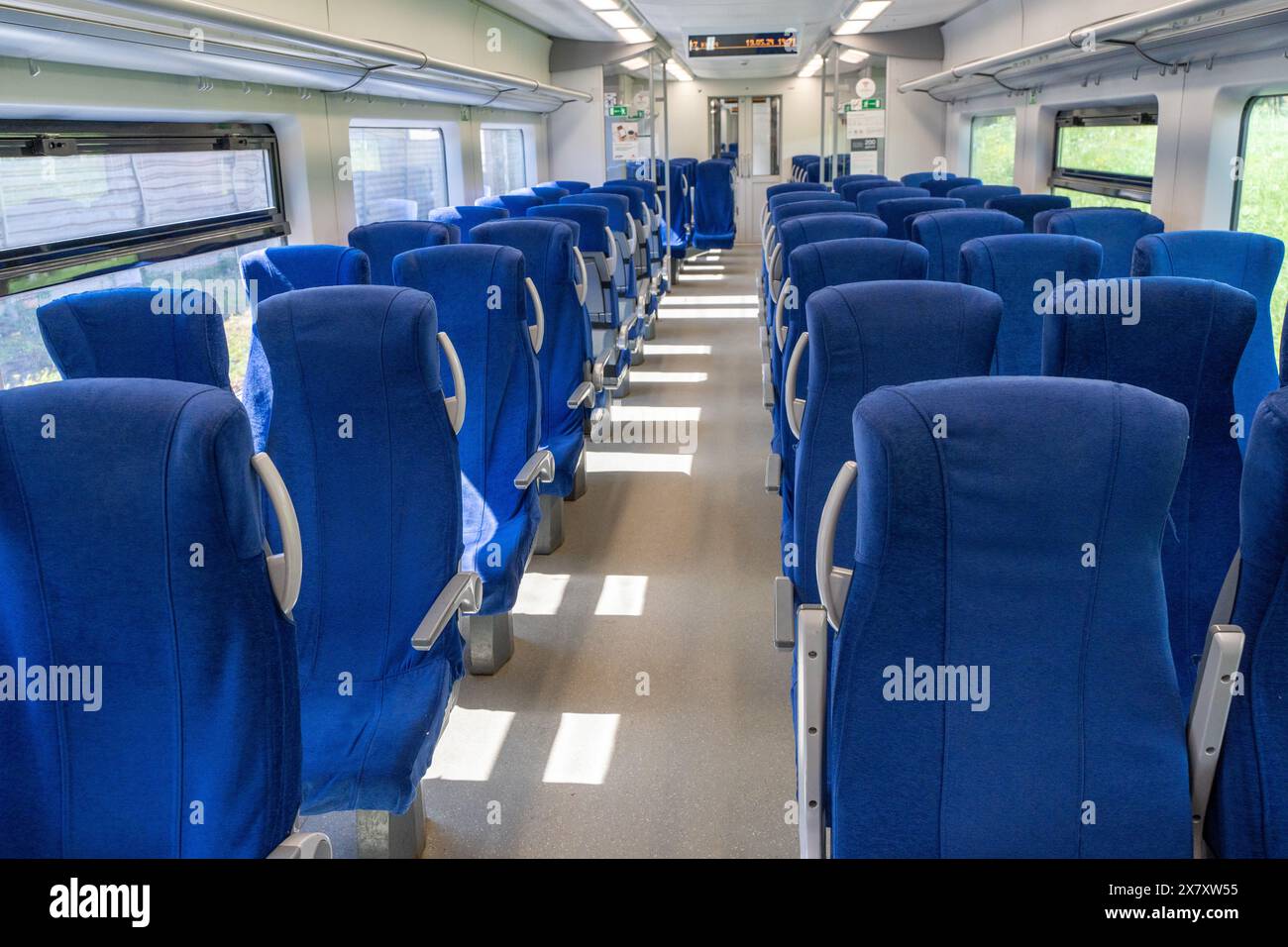 Interior view of modern intercity high speed train coach with rows