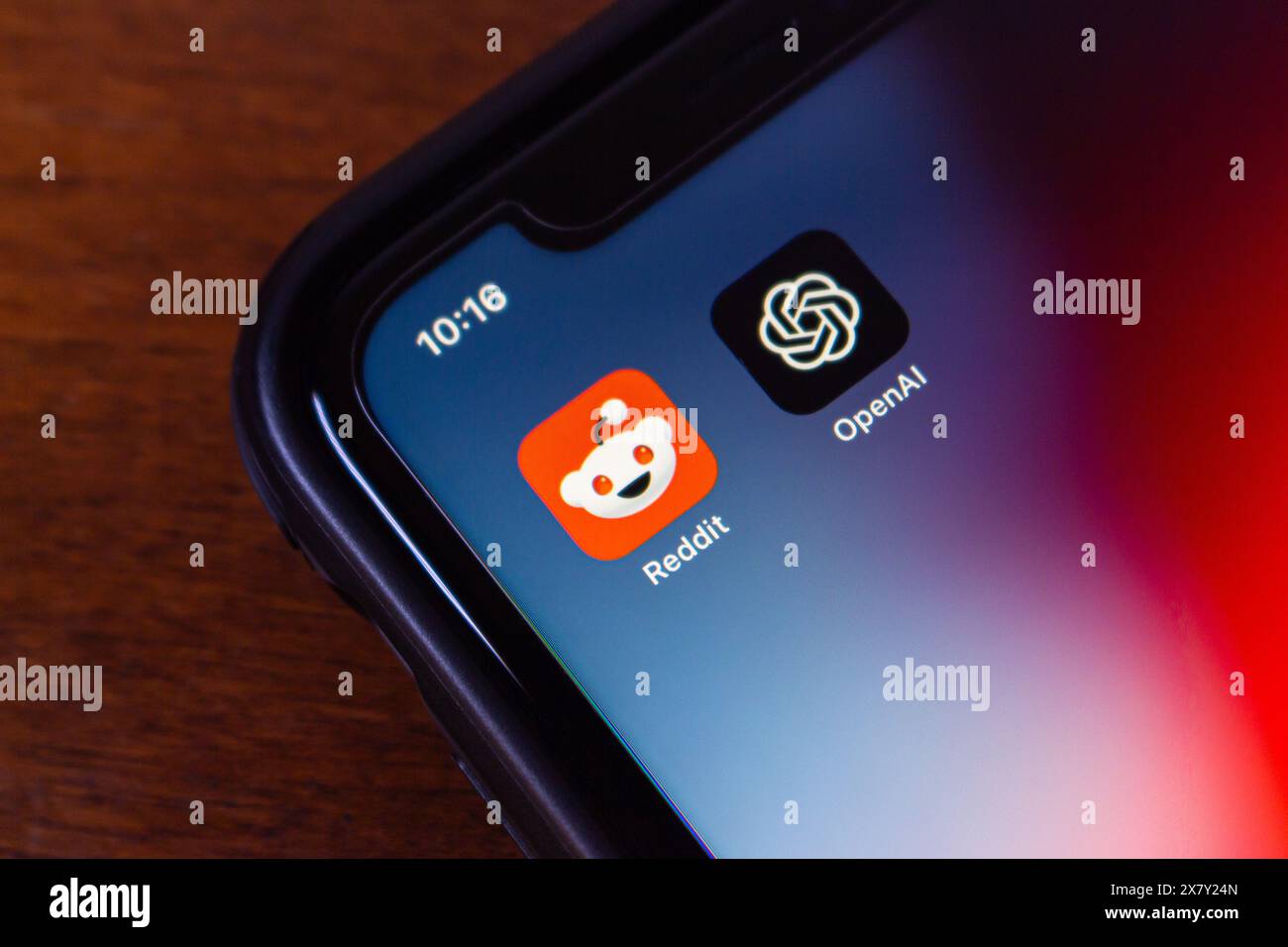 Reddit and OpenAI icons. OpenAI and Reddit announced a partnership to enhance ChatGPT with Reddit content and improve Reddit's UX with AI features. Stock Photo