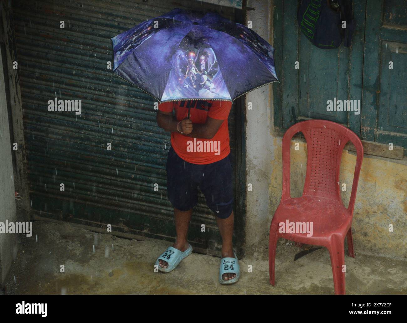 Siliguri, West Bengal, India. 22nd May, 2024. An Indian man uses an umbrella to protect him from the sudden rain in Siliguri. (Credit Image: © Diptendu Dutta/ZUMA Press Wire) EDITORIAL USAGE ONLY! Not for Commercial USAGE! Stock Photo