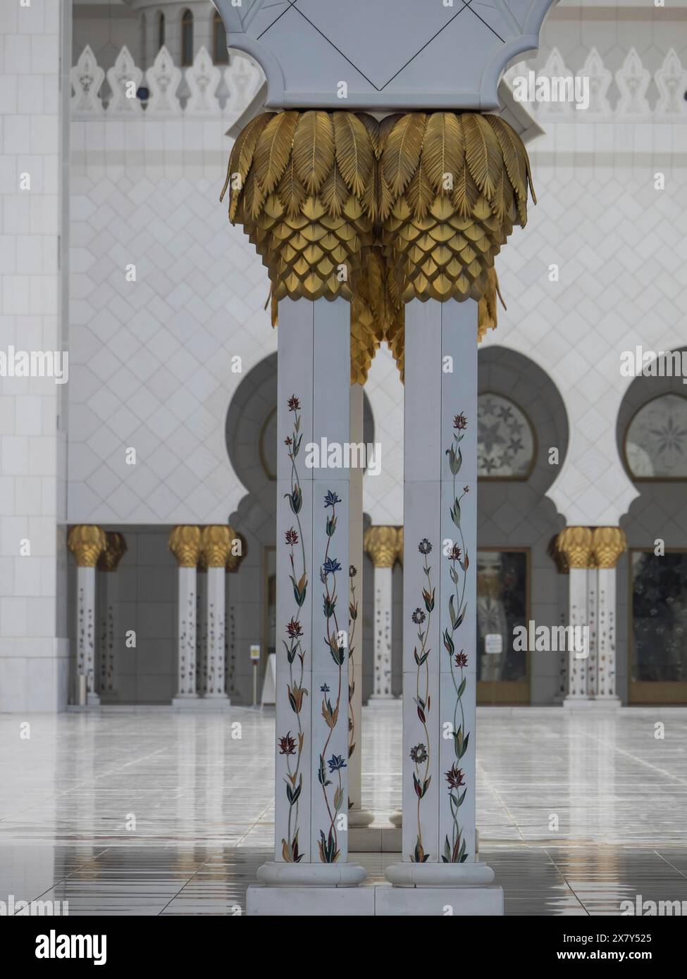 Columns with golden decorations and floral patterns in a mosque, white ...