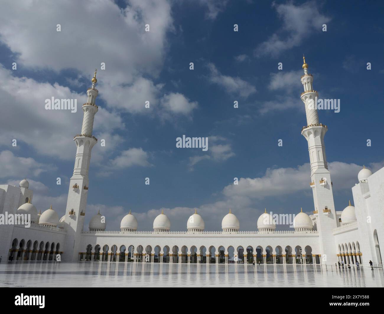 Two Level Mosque Large mosque with two high minarets and numerous white domes under a ...