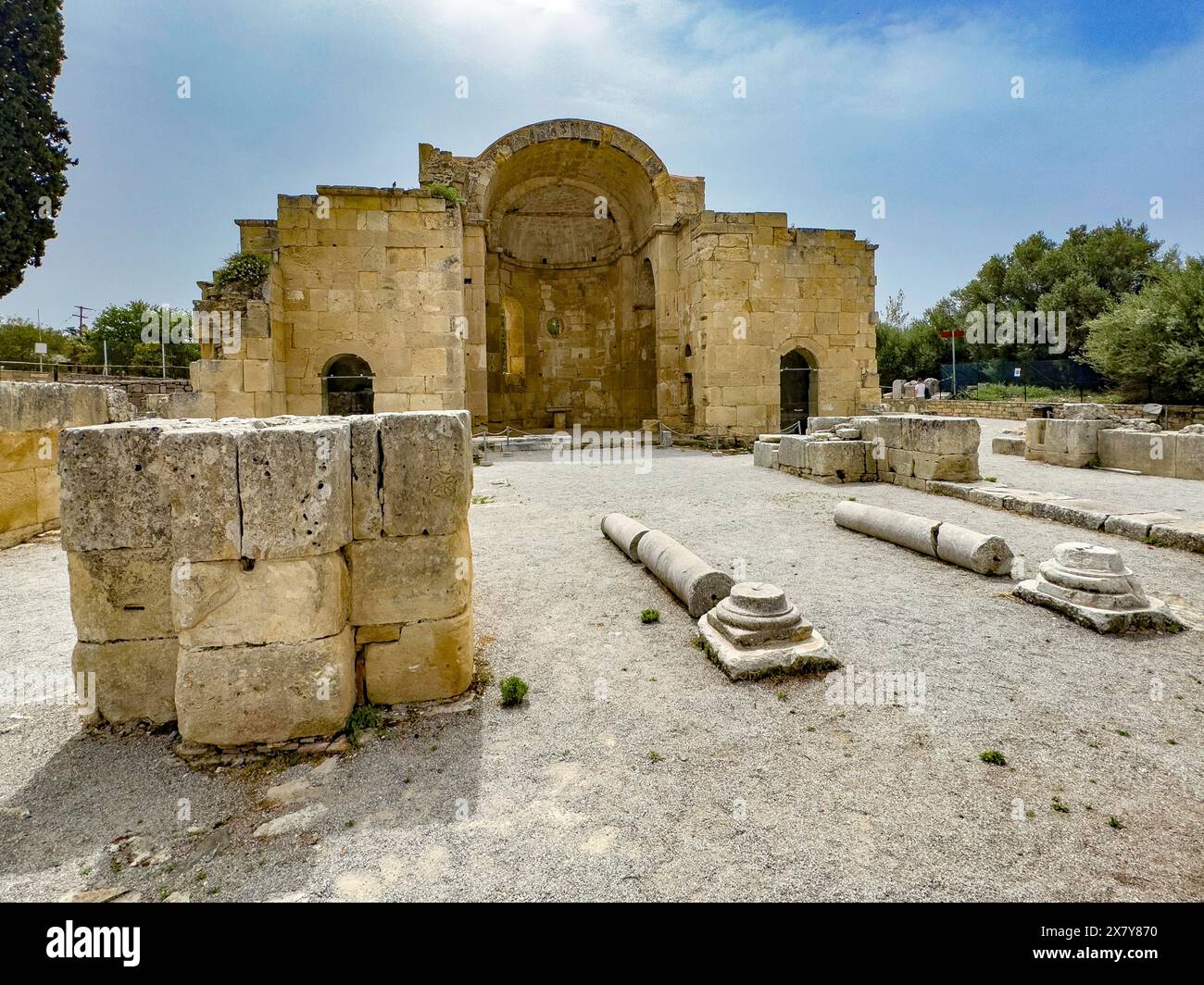 View of ancient ruins of Titus Basilica, in the foreground remains of stones foundation walls of portal next to columns in the background chancel of e Stock Photo