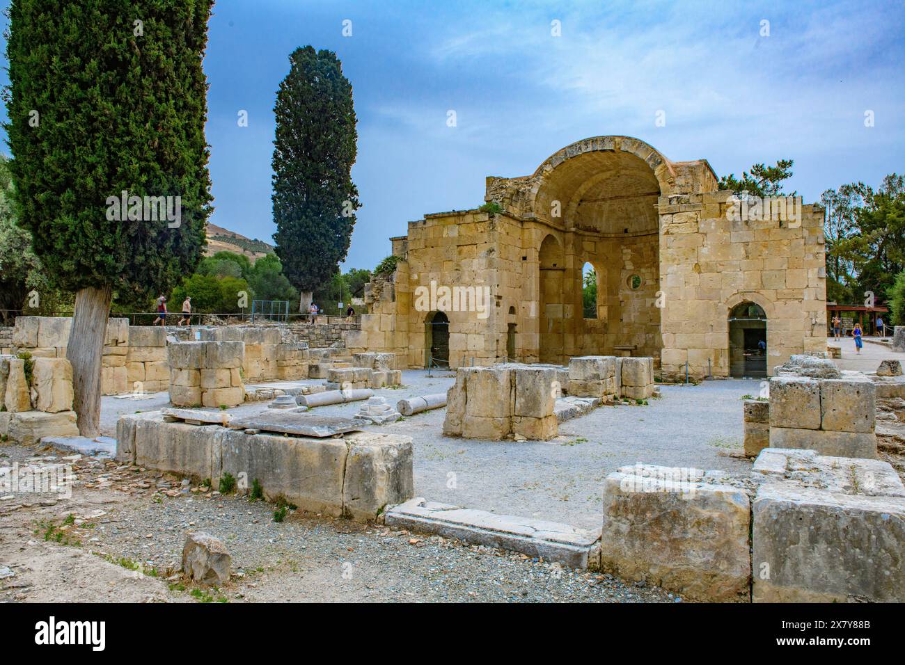 View of ancient ruins of Titus Basilica, in the foreground remains of stones foundation walls of portal next to columns in the background chancel of e Stock Photo