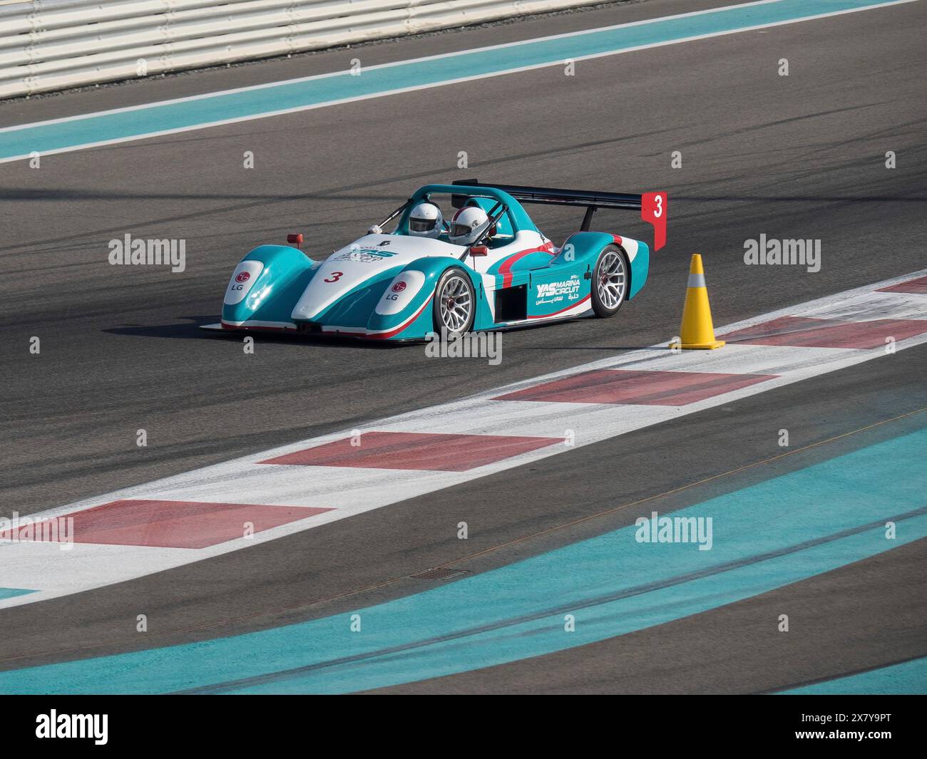A racing car with two drivers at full speed on the race track, passing ...