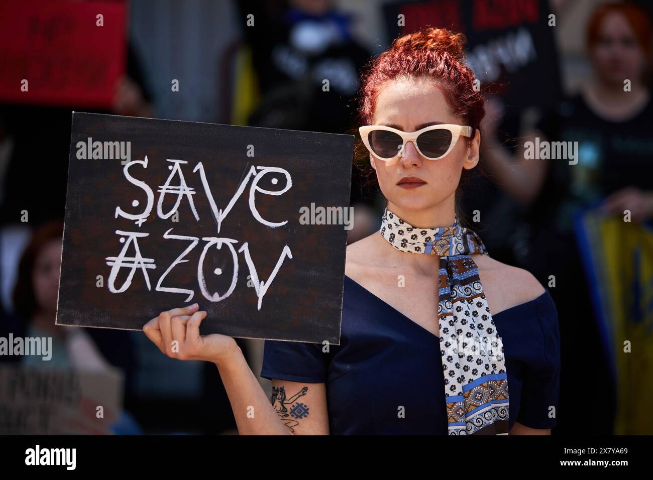 Stylish Ukrainian woman posing with a sign 