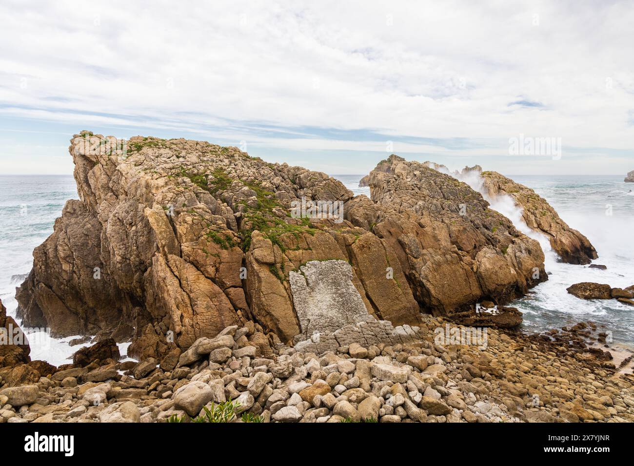 Massive coastal rocks of unusual shape and the stormy Atlantic Ocean. Costa Quebrada Geopark, Cantabria, Spain. Stock Photo