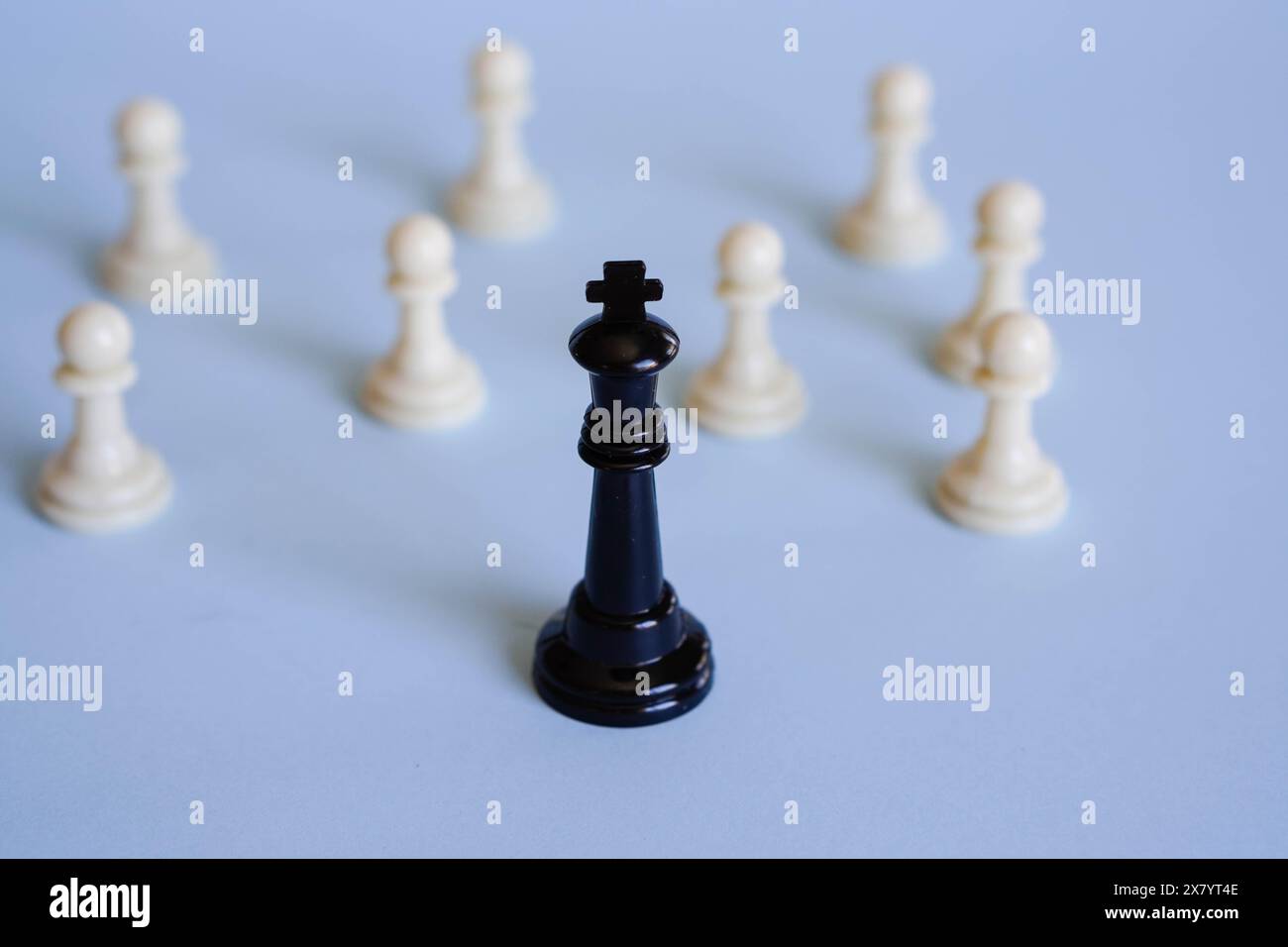 chess king in front of several pawns, representing the role of leadership and guidance. Stock Photo