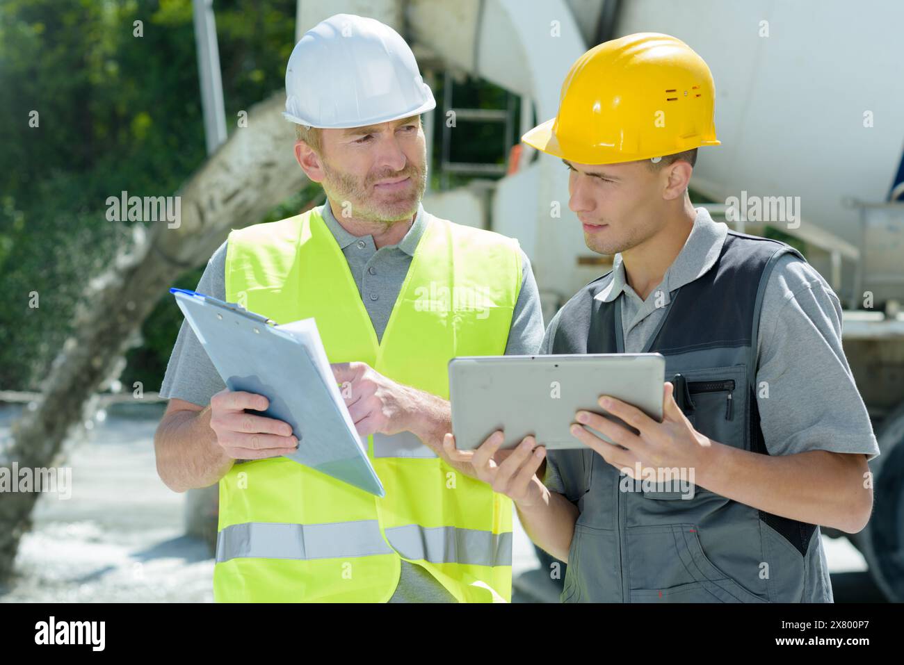 two construction workers are outdoors Stock Photo