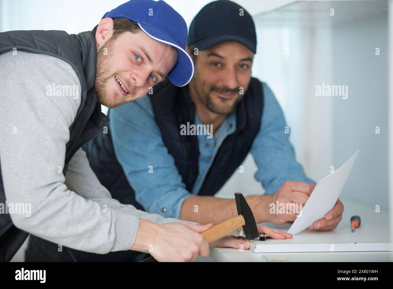 two men fitting a new kitchen Stock Photo