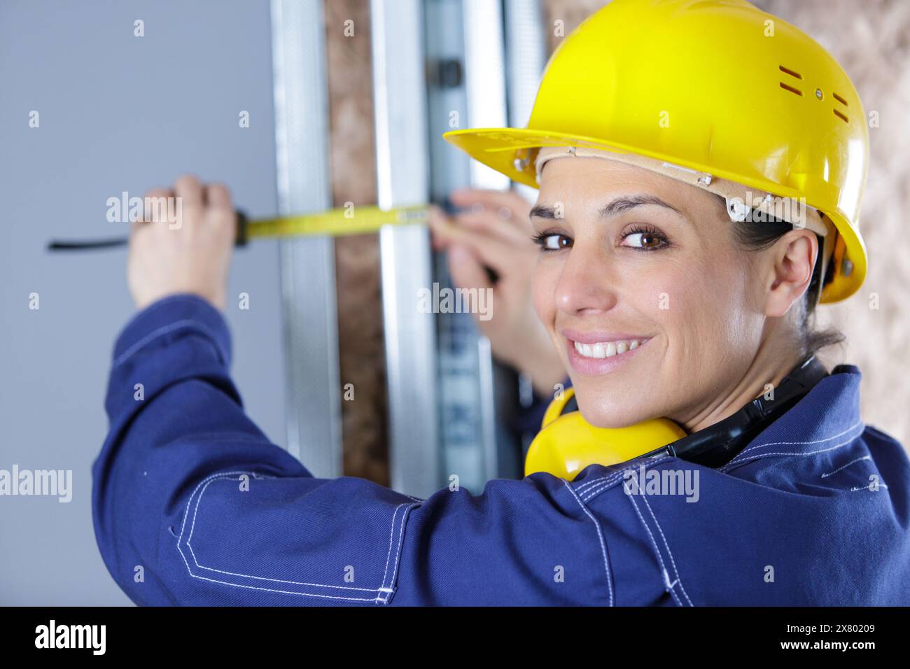 happy woman measuring wood wall Stock Photo