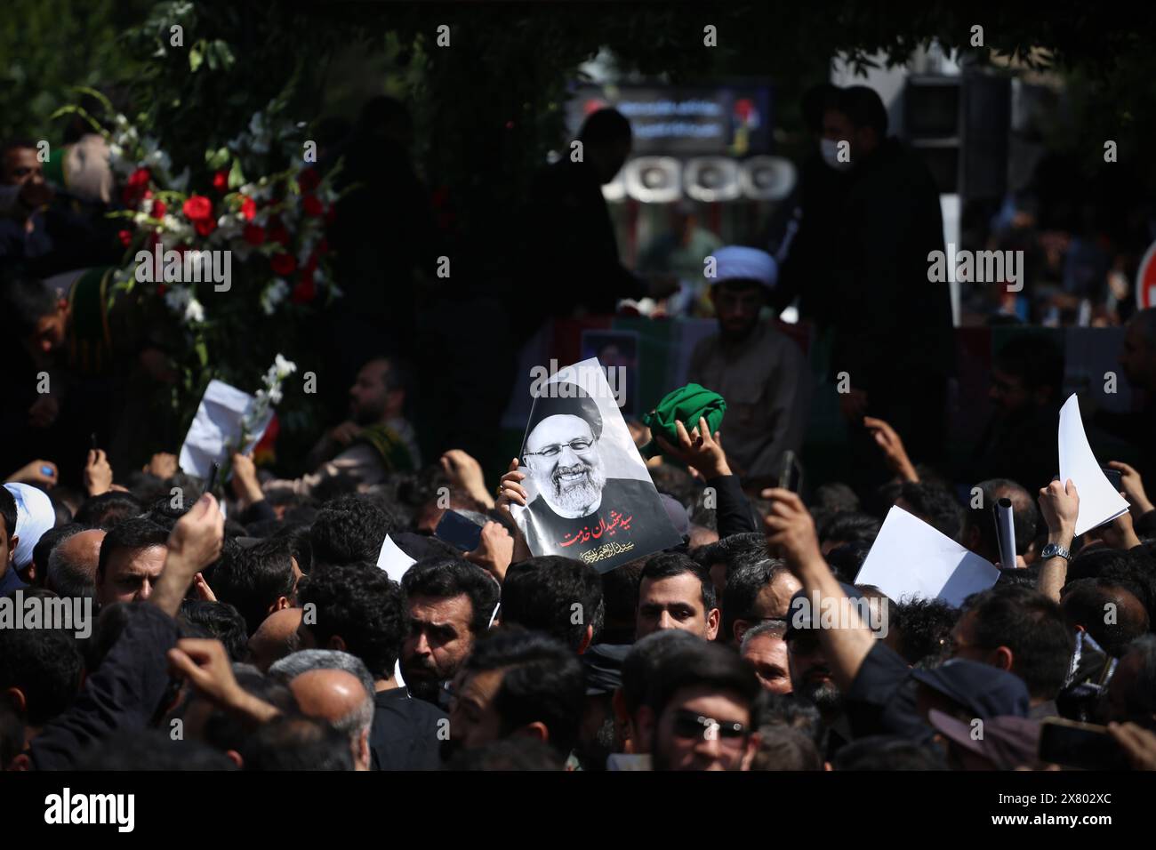 Tehran, Iran. Tehran, Iran. 22nd May, 2024. An Iranian holds up a poster of the late President Ebrahim Raisi, who was killed in a helicopter crash in a mountainous region of the country's northwest, during a funeral ceremony for them in Tehran. Credit: ZUMA Press, Inc./Alamy Live News Stock Photo