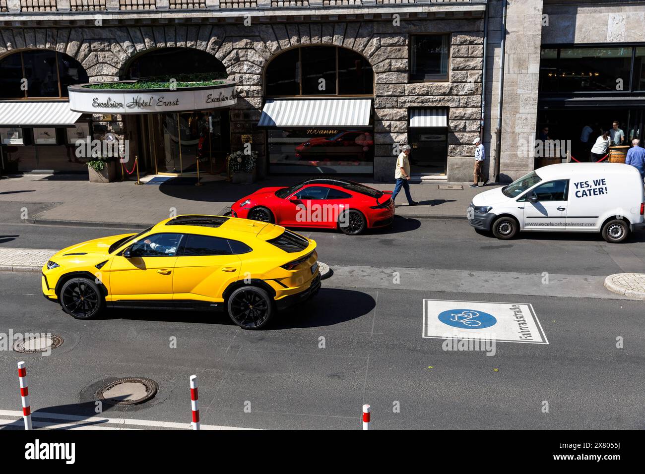 a Porsche 911 and a Lamborghini Urus stand in front of the of the Excelsior Hotel Ernst, Cologne, Germany ein Porsche 911 und ein Lamborghini Urus ste Stock Photo