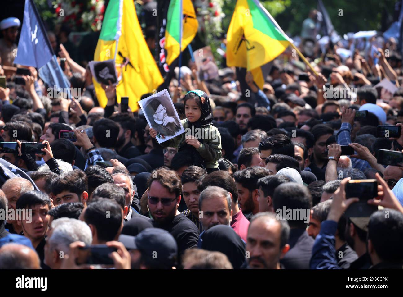 Tehran, Iran. Tehran, Iran. 22nd May, 2024. An Iranian child girl holds a poster during a funeral ceremony for the late President Ebrahim Raisi and his companions who were killed during a helicopter crash in a mountainous region of the country's northwest, in Tehran. Credit: ZUMA Press, Inc./Alamy Live News Stock Photo
