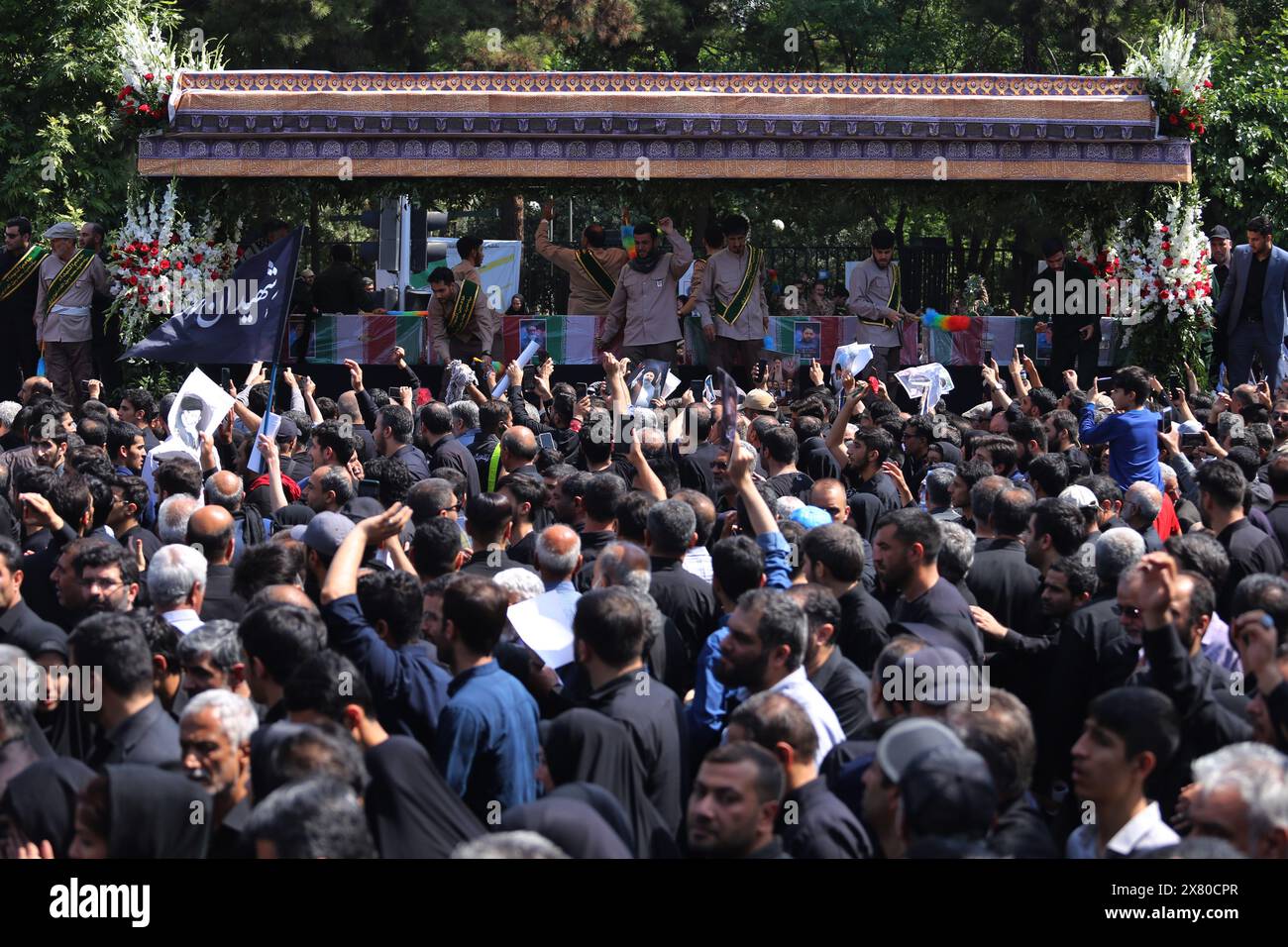 Tehran, Iran. May 22, 2024, Tehran, Iran: Iranians mourners follow a truck carrying coffins of the late President Ebrahim Raisi and his companions, who were killed in a helicopter crash in a mountainous region of the country's northwest, during a funeral ceremony for them in Tehran. Credit: ZUMA Press, Inc./Alamy Live News Stock Photo