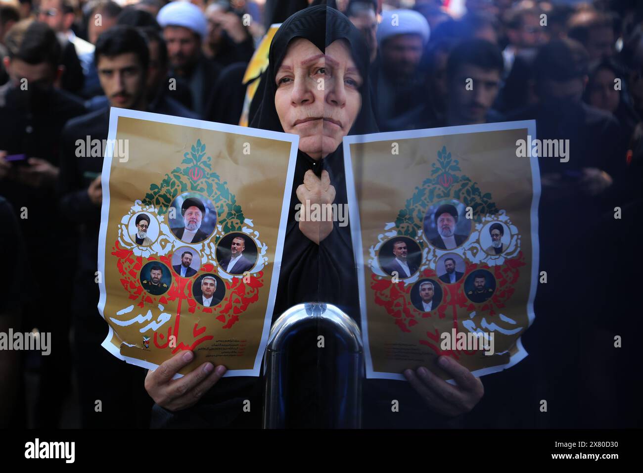 Tehran, Iran. May 22, 2024, Tehran, Iran: An Iranian veiled woman holds a poster during a funeral ceremony for the late President Ebrahim Raisi and his companions, who were killed during a helicopter crash in a mountainous region of the country's northwest in Tehran. Credit: ZUMA Press, Inc./Alamy Live News Stock Photo