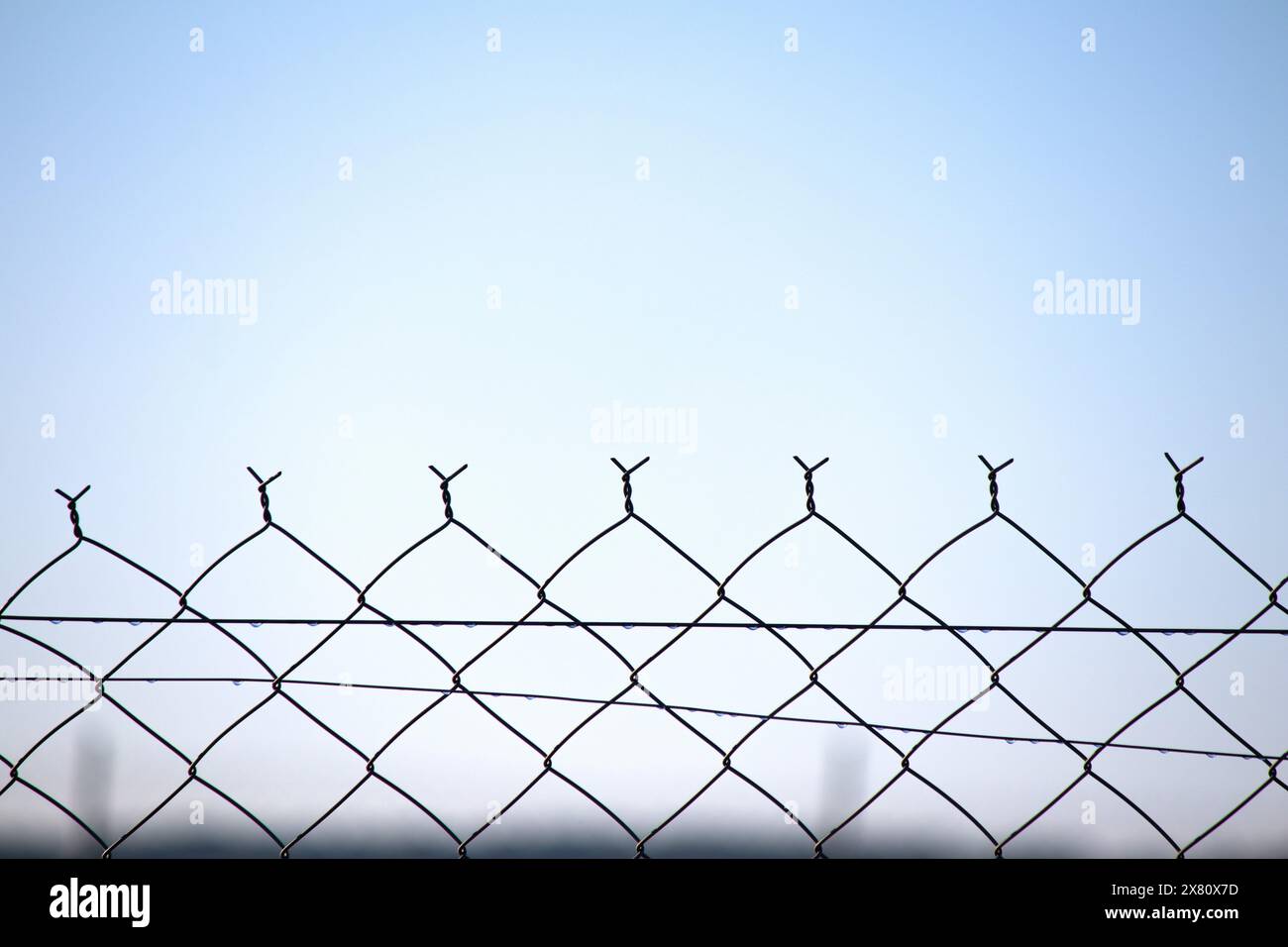 Stainless steel fencing wire. Garden wires are networks woven with steel cables. Terrace fence or railing isolated on white background. Safety. Stock Photo