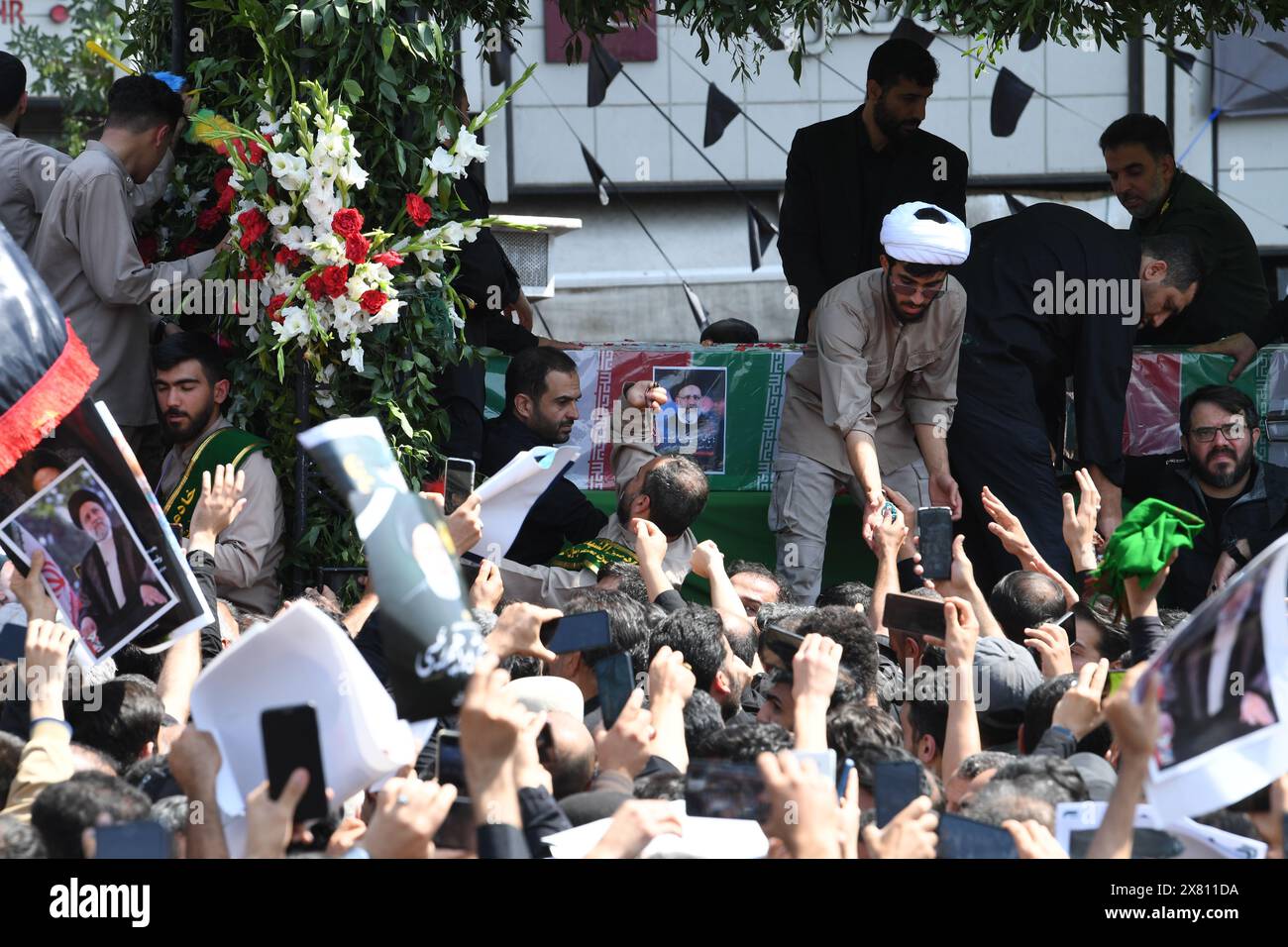 Tehran, Iran. 22nd May, 2024. People attend a memorial event held for Iran's late President Ebrahim Raisi, late Foreign Minister Hossein Amir-Abdollahian and others in Tehran, Iran, May 22, 2024. Credit: Shadati/Xinhua/Alamy Live News Stock Photo