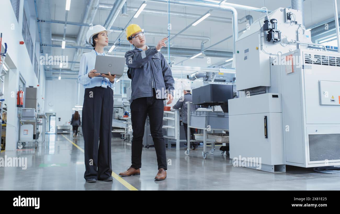 Two Professional Heavy Industry Employees Wearing Hard Hats at Factory ...