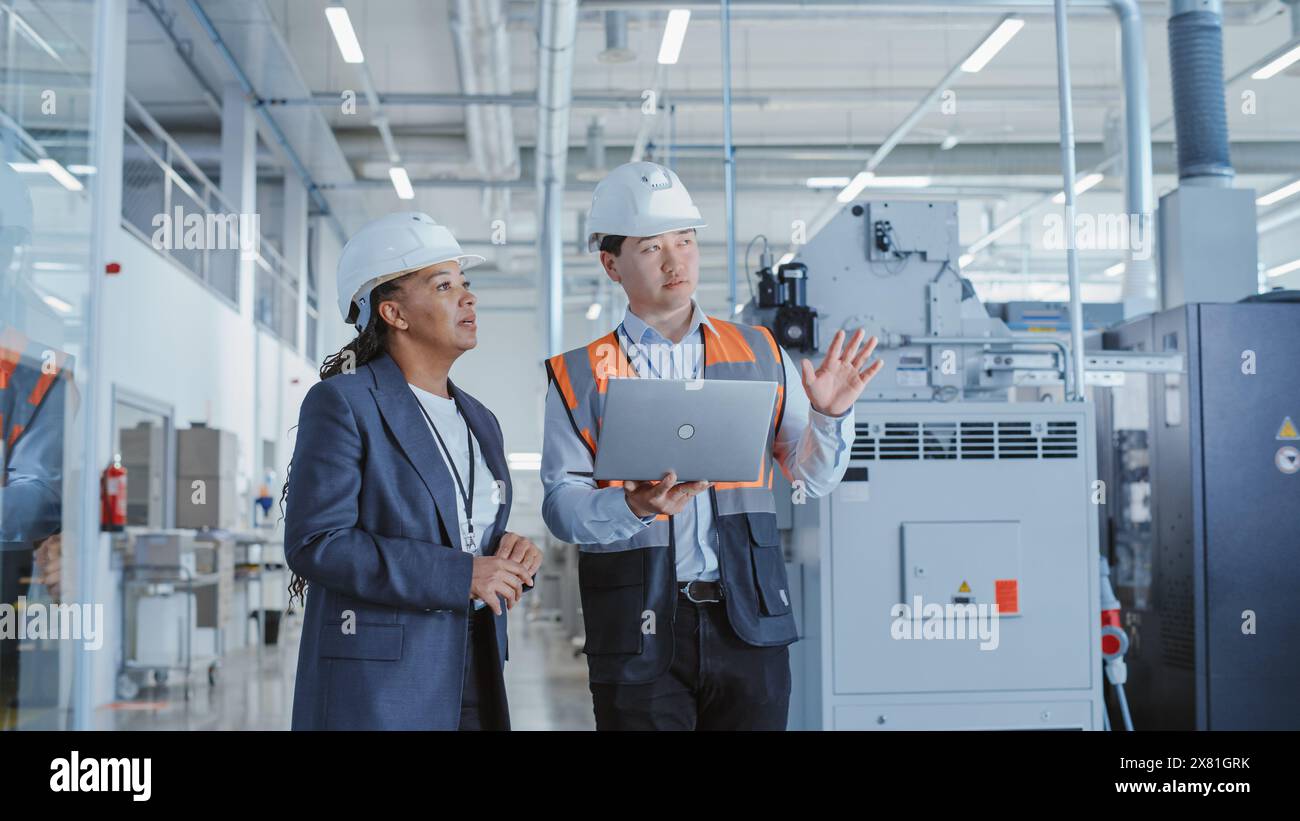 Two Professional Heavy Industry Employees in Hard Hats at Factory ...