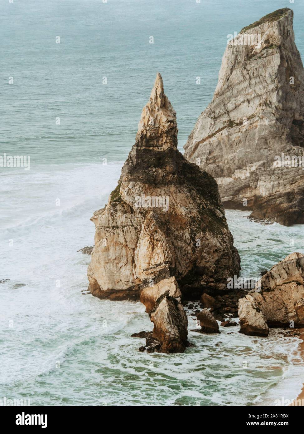 View from the observation deck of impressive sea cliffs rising from the ocean in the rays of the setting sun Stock Photo