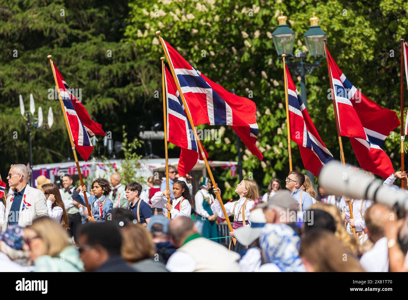 Oslo, Norway. 17th, May 2024. People parade with the flag of Norway