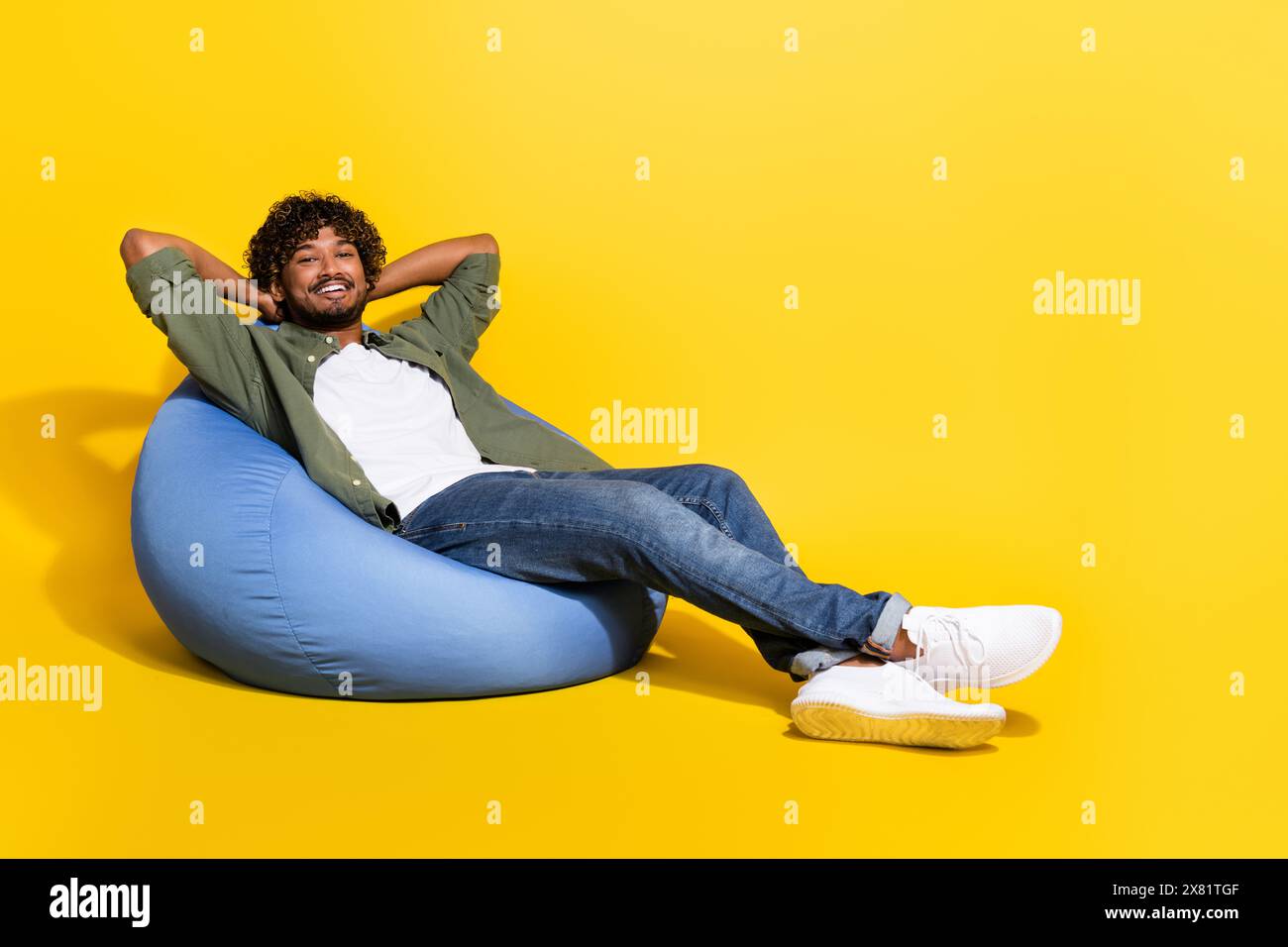 Portrait photo of young funny mexican guy in khaki shirt lying beanbag dreaming about better life isolated on yellow color background Stock Photo Alamy