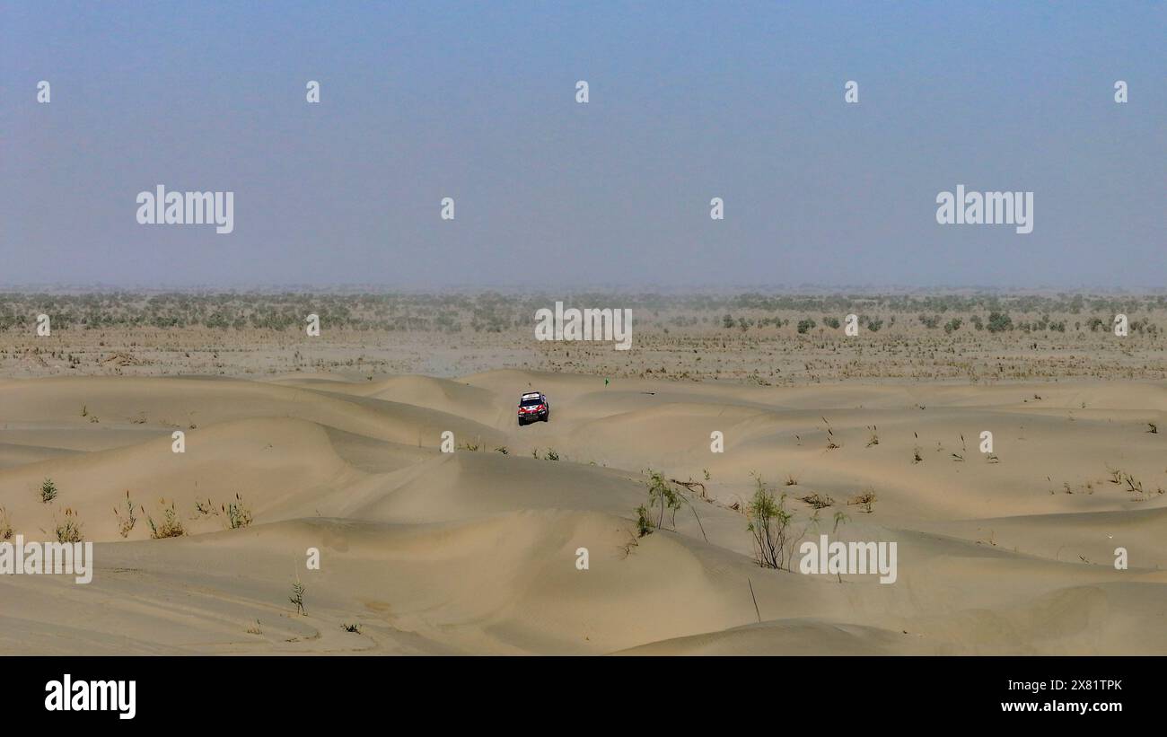 Kashgar. 22nd May, 2024. An aerial drone photo taken on May 22, 2024 shows that driver Sun Hao of China and his pilot Wang Dongdong of China compete during the second stage at the 2024 Taklimakan Rally in Kashgar, China's northwestern Xinjiang Uygur Autonomous Region. Credit: Chen Shuo/Xinhua/Alamy Live News Stock Photo