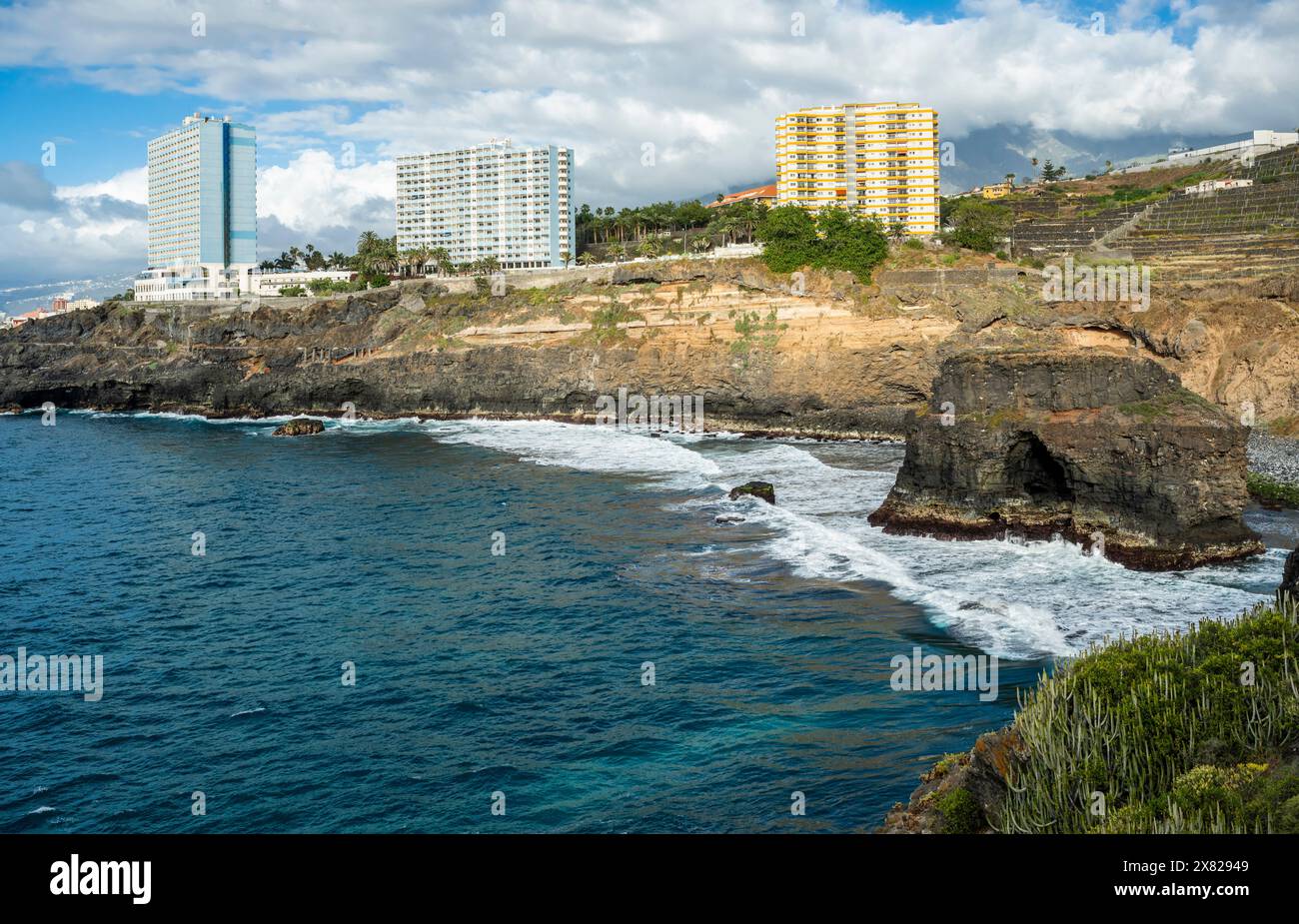 The coastline at Rambla de Castro walking path near Puerto de la Cruz on north coast of Tenerife, Canary Islands, with Roque Chico sea arch Stock Photo