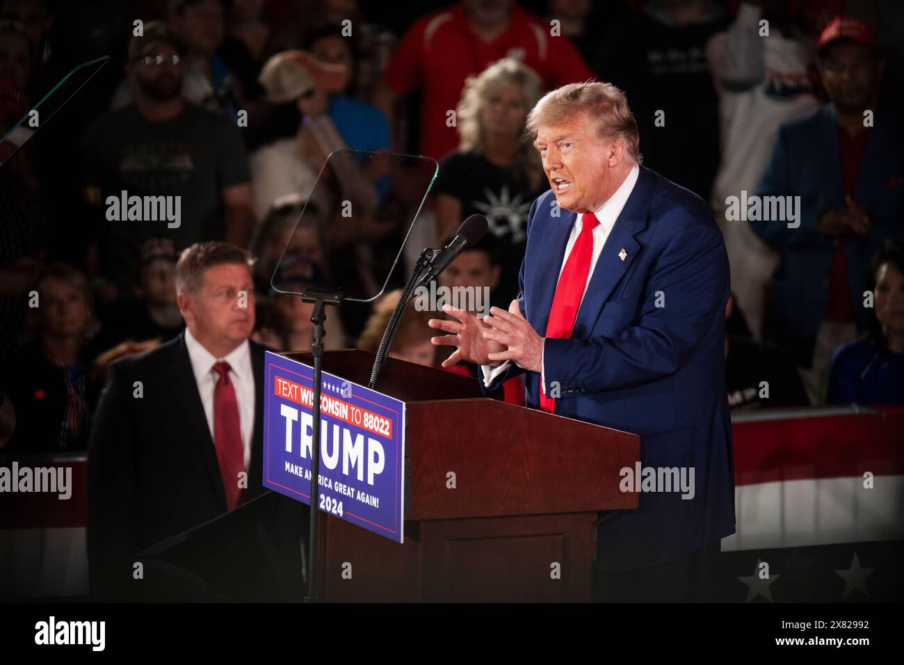 Donald Trump speaks on stage and uses hand gestures at a campaign rally in Waukesha, Wisconsin on Wednesday May 1st, 2024. Stock Photo